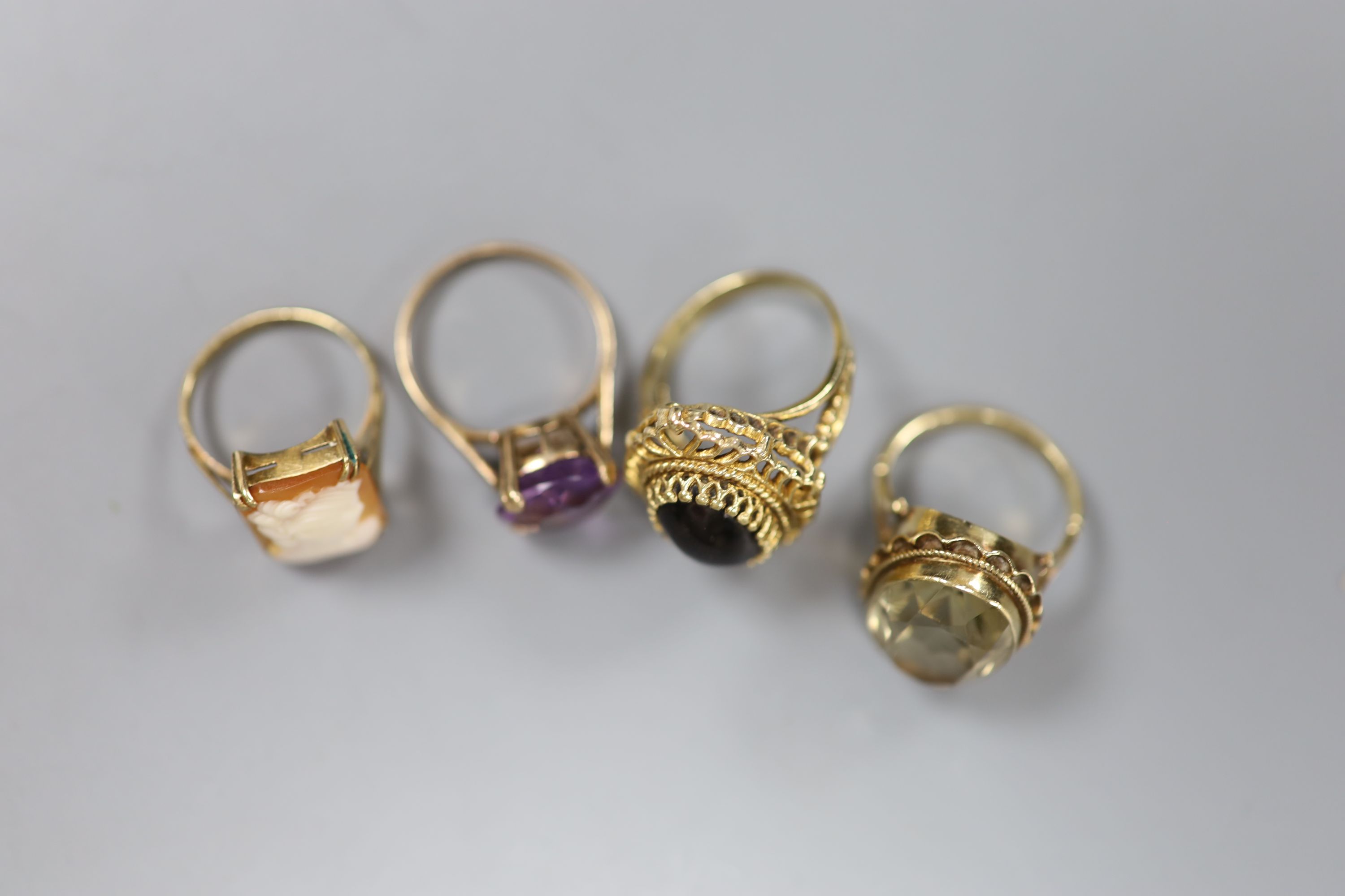 A Renaissance style cabochon garnet ring, 9ct gold stepped pierced setting, 7.2g and three other 9ct dress rings,